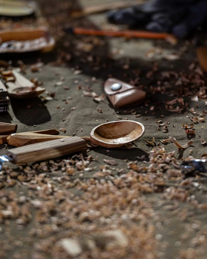 Wood-carving tools and shavings on a workbench
