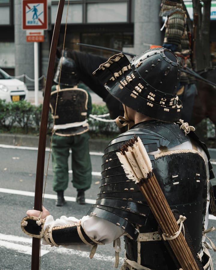 A samurai in armour with a bow and a quiver of arrows
