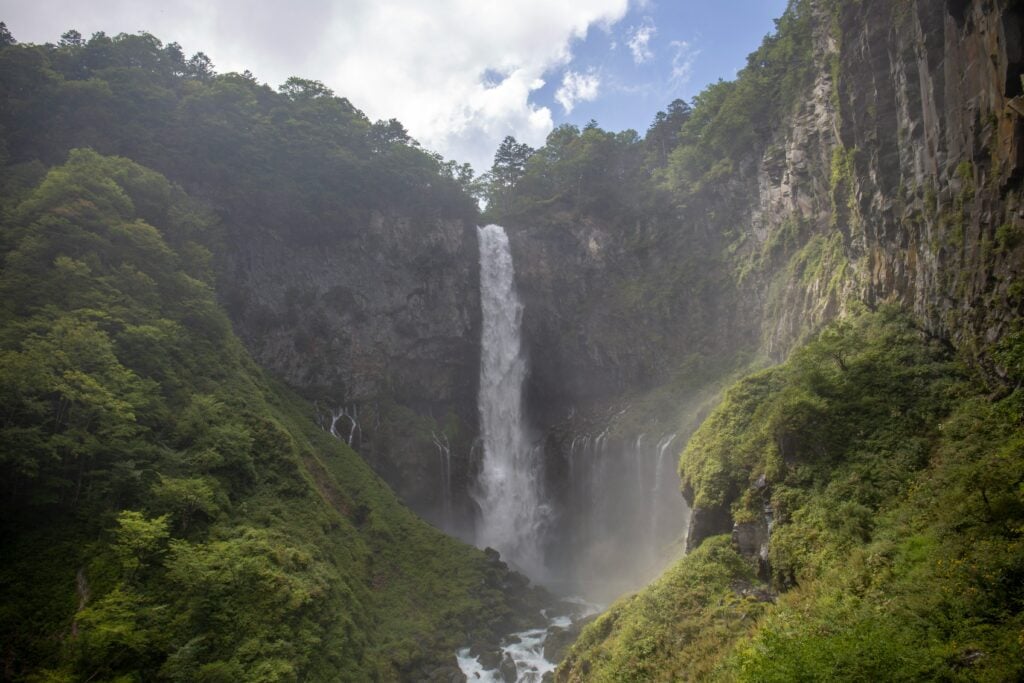 Kegon Falls surrounded by cliffs and forest in Nikko, Japan